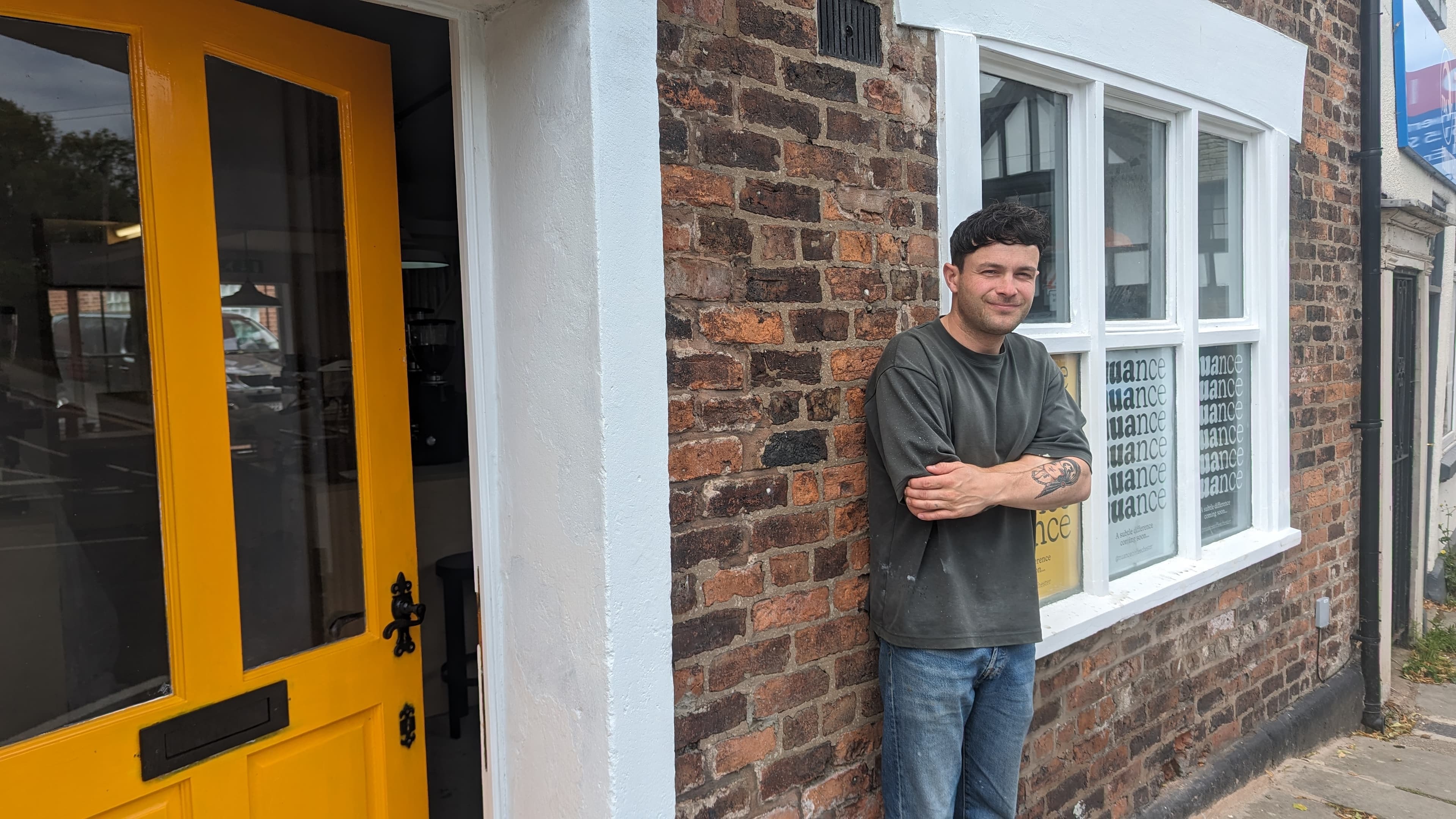 Jake standing outside Nuance's orange door on Handbridge